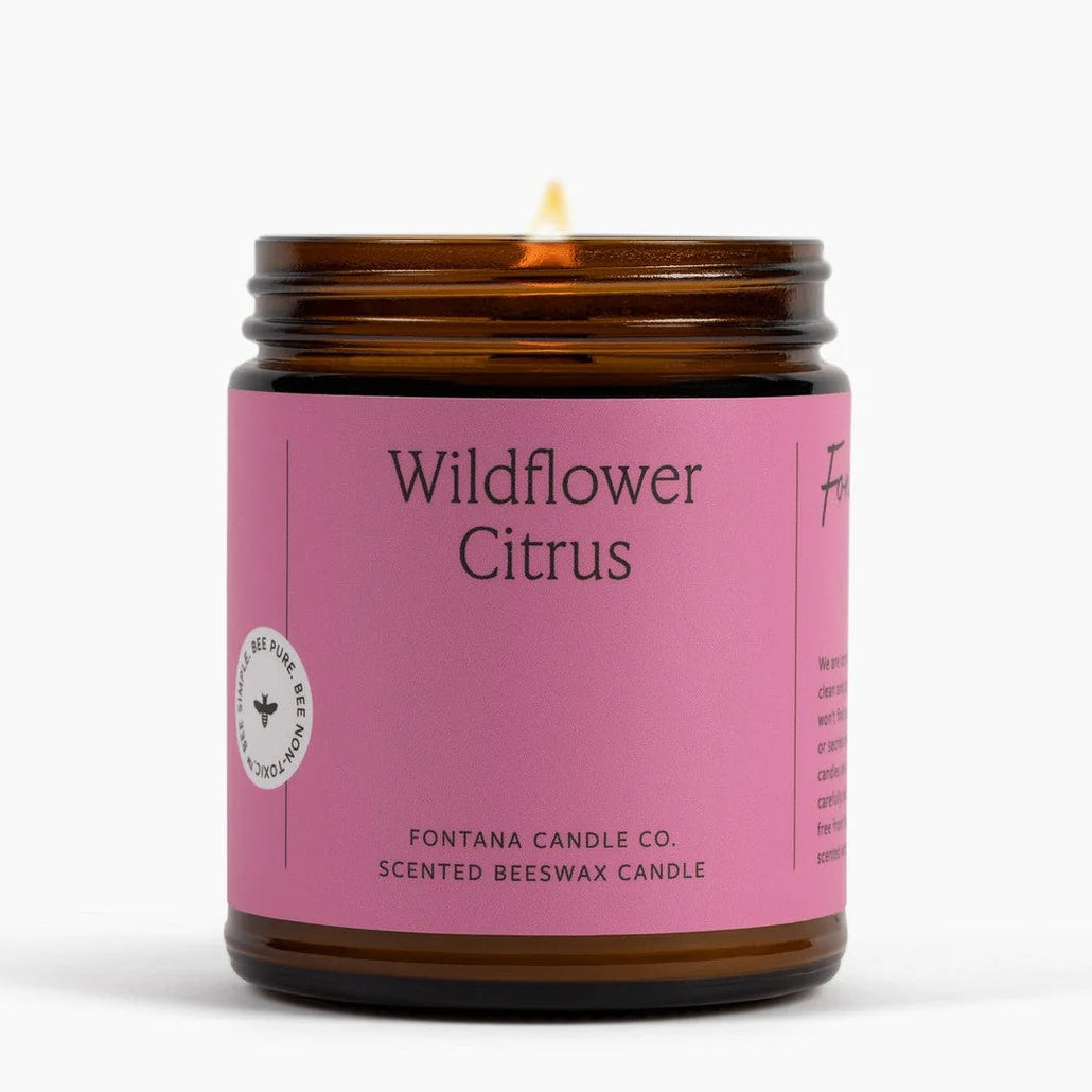 Candle with a pink label reading &
