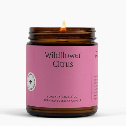 Candle with a pink label reading &