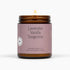 Lavender Vanilla Tangerine candle in an amber jar with a purple label on a white background