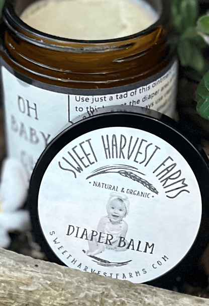 Jar of Sweet Harvest Farms diaper balm with a child&