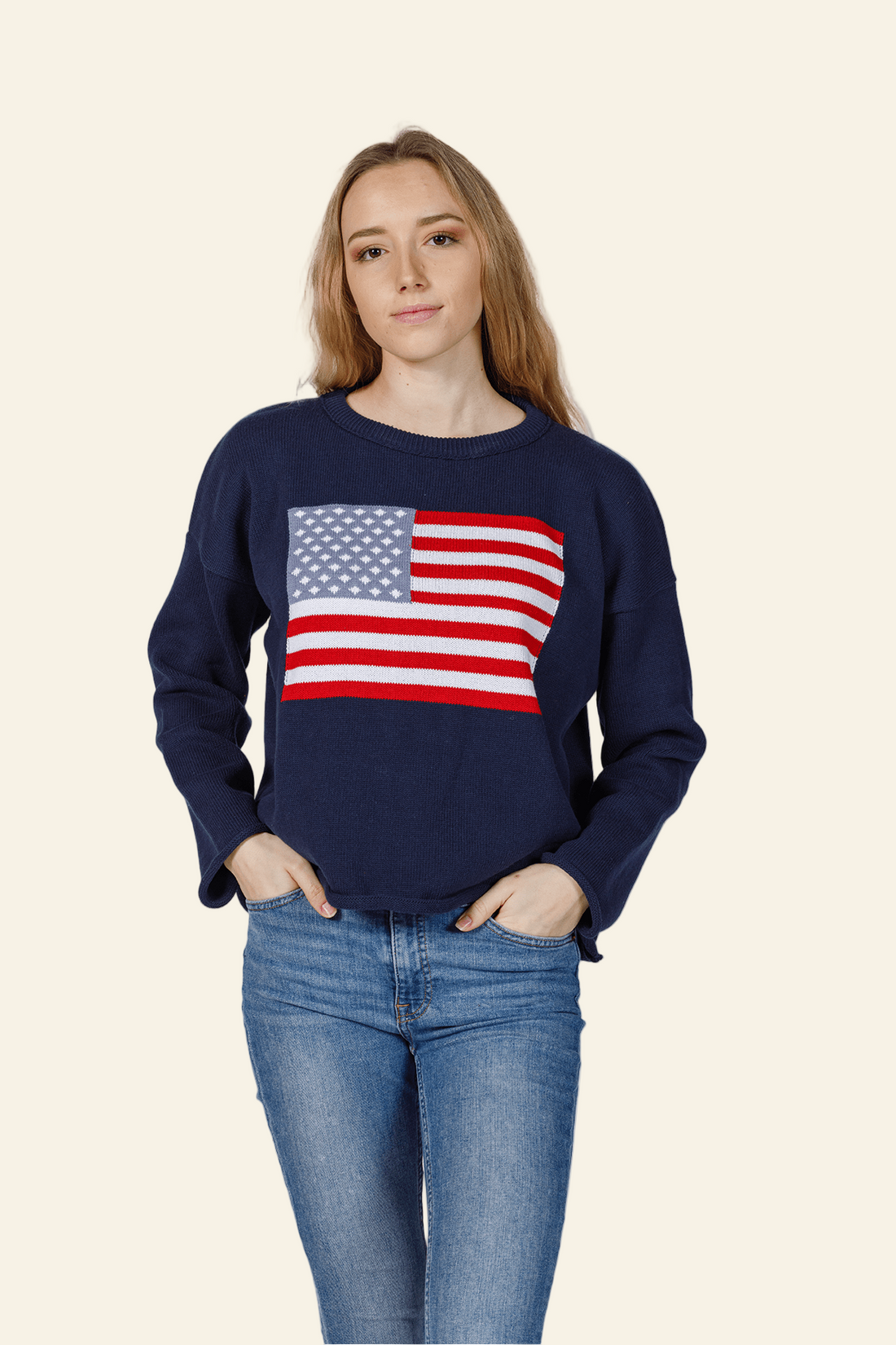 Person wearing a navy blue sweatshirt with an American flag design on a white background