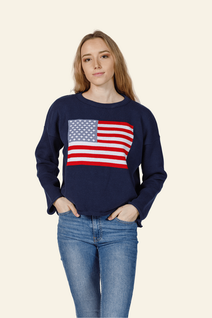 Person wearing a navy blue sweatshirt with an American flag design on a white background